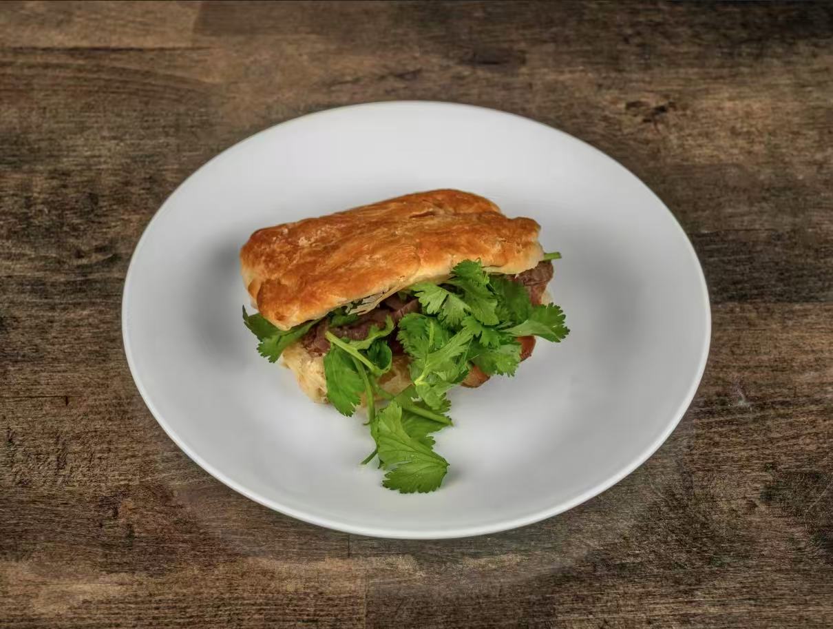 Flaky pastry bun stuffed with tender beef, fresh cilantro at Village Bao 又一村包子，a Chinese Restaurant in Sugar Land