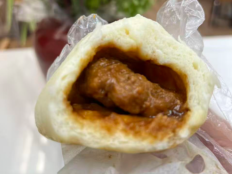 Soft bun filled with pork in rich savory sauce at Village Bao 又一村包子，a Chinese Restaurant in Sugar Land